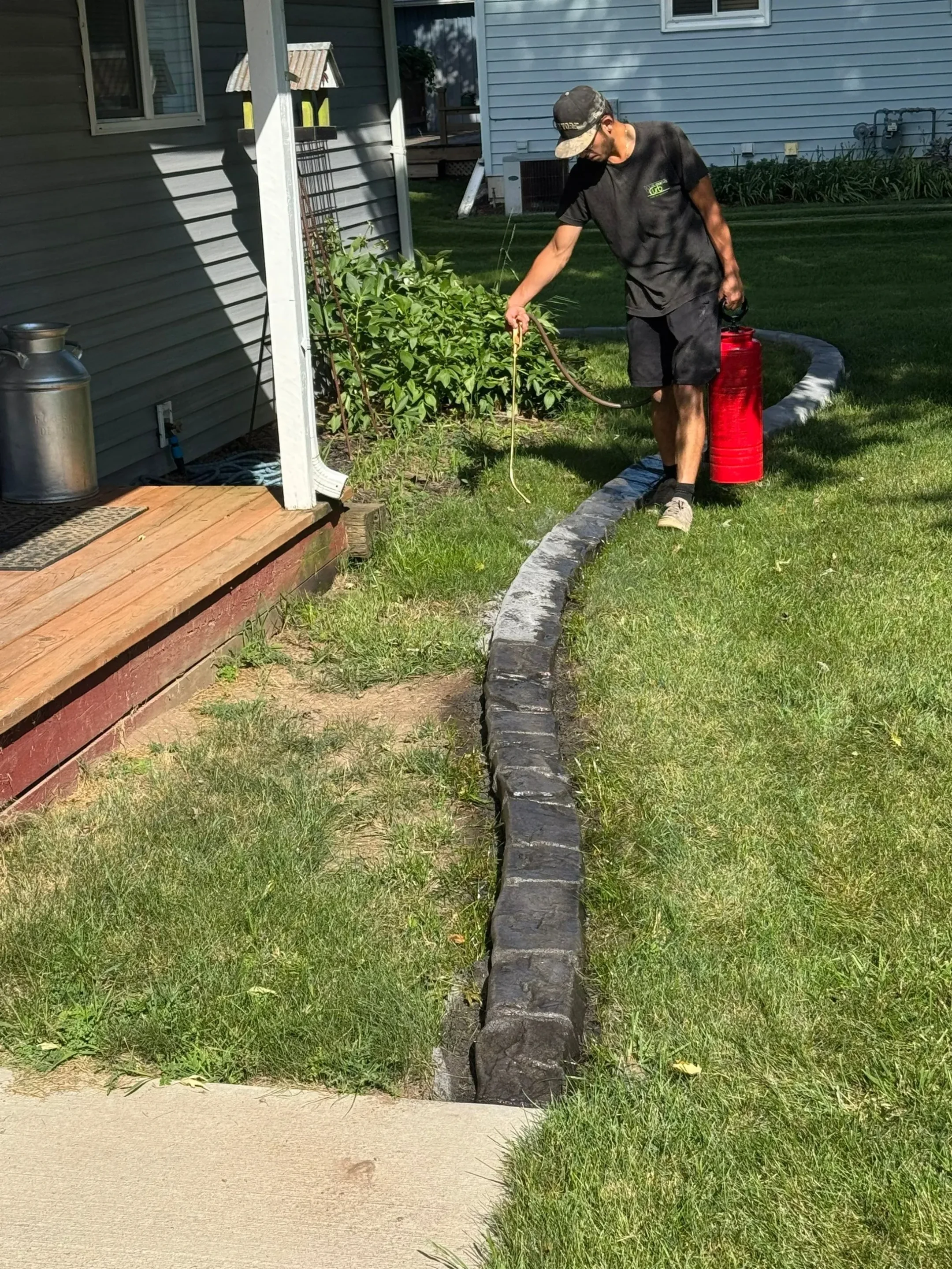Straight curbing along driveway with ornamental grasses