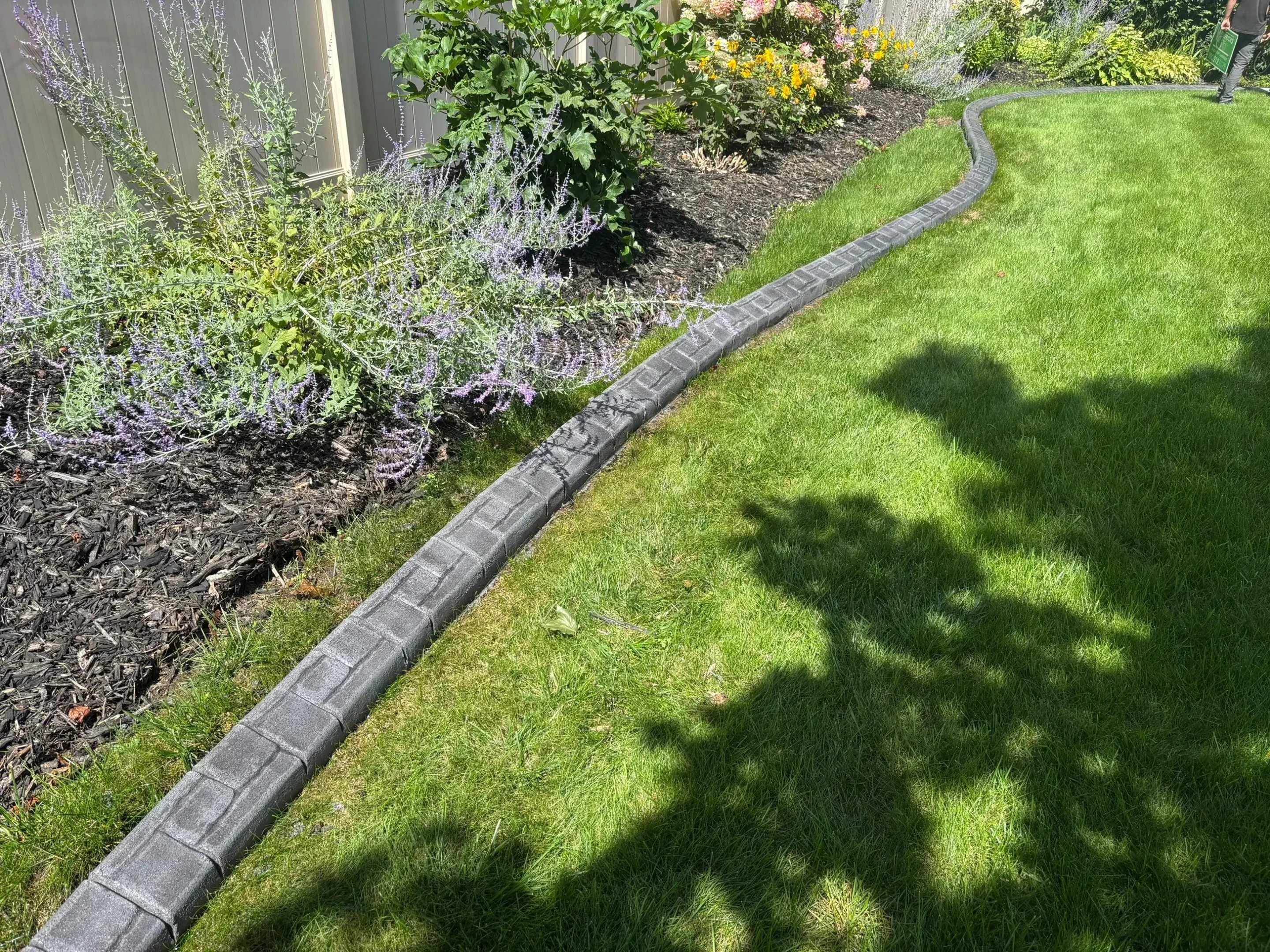 Professional landscape curbing tools and equipment on a Minnesota residential property